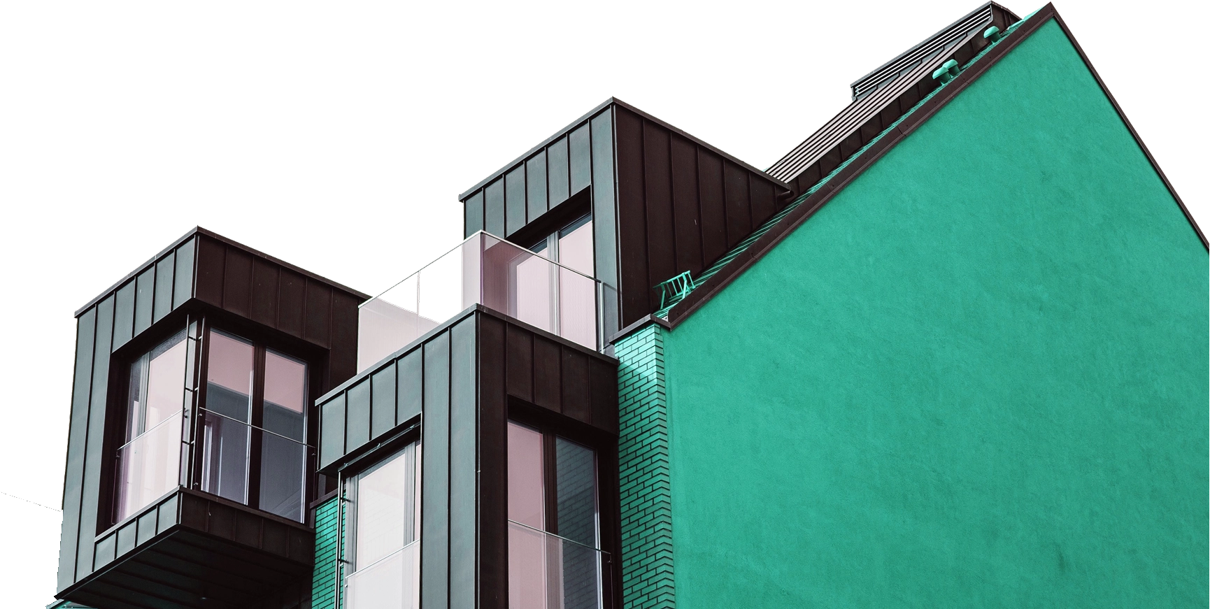 Modernes Gebäude mit schwarzen Metallfassaden und einem großen hellgrünen Putz an der Seite.